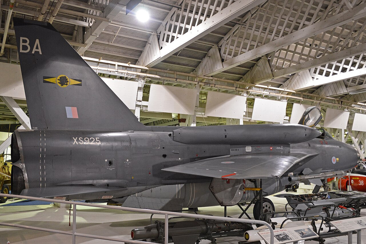 Lightning F6 XS925 seen from behind and to the side in a museum hangar.