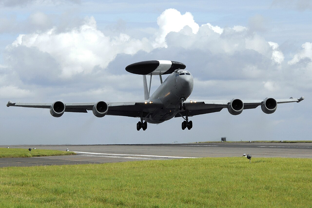 An RAF E-3D Sentry taking off, with four engines and a radar dome above the fuselage.