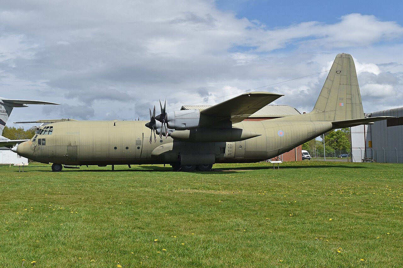 Hercules C3 viewed from the side, showing its nose, cockpit, propellers, landing gear and tall tail. Part of the tailplane extends beyond the frame.