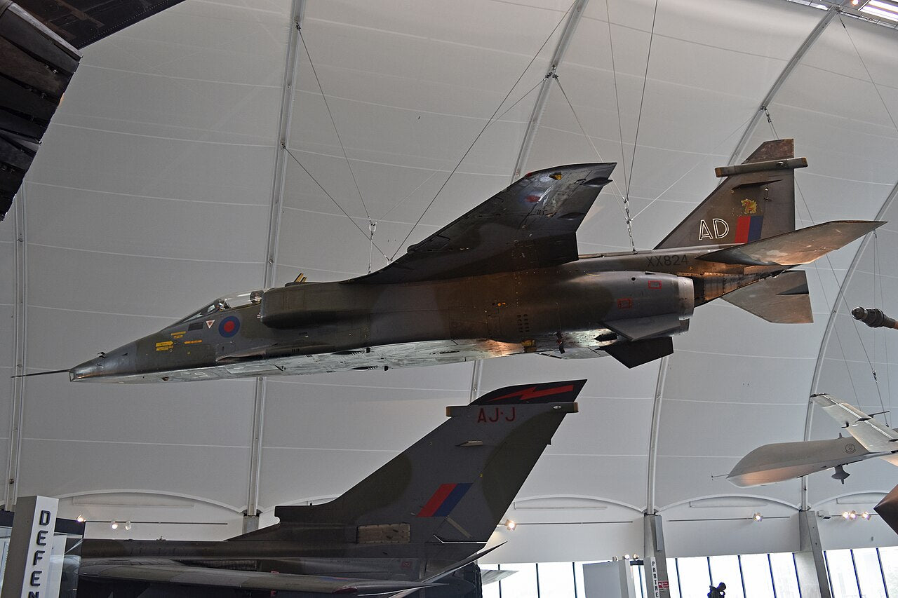 Jaguar GR1 XX824 suspended in a museum hangar, seen from below and to the side.