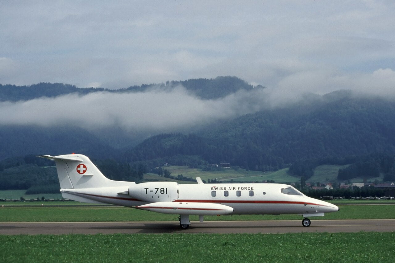 Side view of white Learjet 35A T-781, with wingtip tanks and rear-mounted engines, on the ground at Zeltweg.